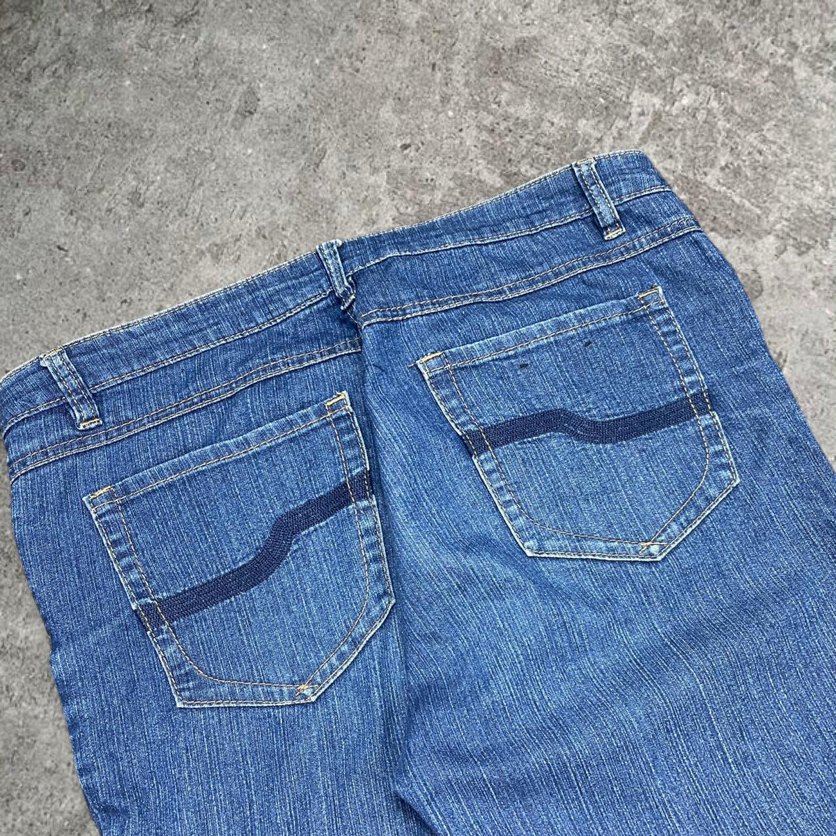 Cute 2000s bootcut low rise embroidered washed jeans, measures 34W x 35.5” outseam length